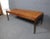Absolutely stunning mid-century rosewood coffee table. A large tabletop, bold lines, and tapered legs show off the wood...