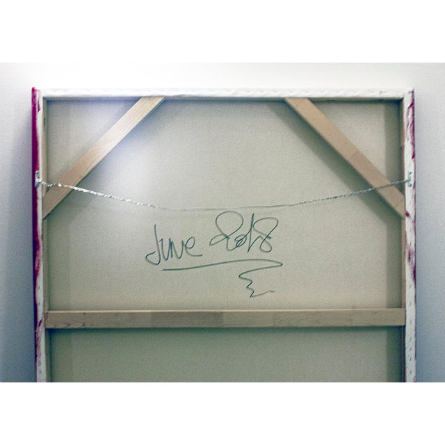 A large-scale abstract composition built on saturated reds that form the dominant field, articulated by interlocking...