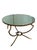 An elegant and sculptural round accent table by Baker Furniture, featuring a beautifully antiqued mirrored top supported...