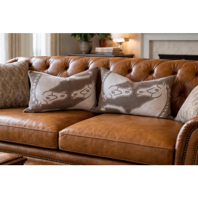 Offering a pair of William Sonoma lambswool lumbar reversible pillows featuring a timeless equestrian motif in warm taupe...