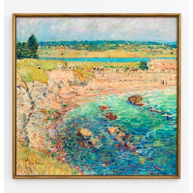 This vintage coastal art print features turquoise water, a rocky shoreline, and sunlit beachgoers, reproduced from Childe...