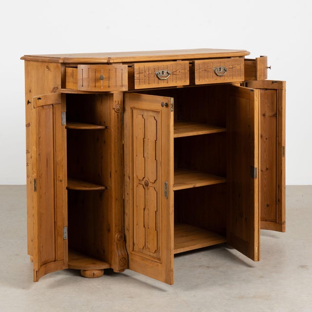 19th century Swedish sideboard, crafted in pine with a tall silhouette. Four upper drawers are positioned above four...