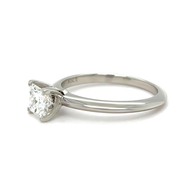 A timeless Tiffany & Co. engagement ring crafted in platinum, featuring a stunning princess cut diamond in a classic...