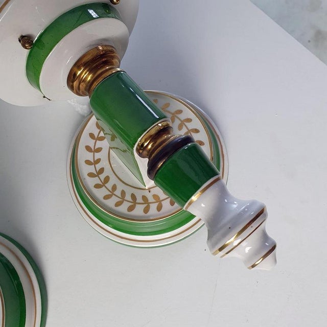 A pair of mid-century wall sconces imitating street wall lights produced around 1970's. The style is very much Guilded...
