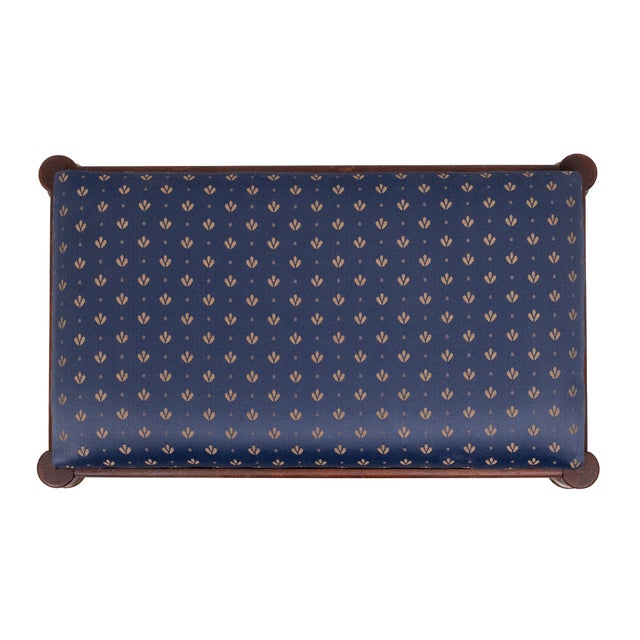 Very nice wooden Ottoman or foot stool . Blue Silk upholstery . Brass details , good used condition .