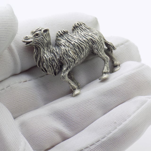 A finely crafted camel figurine emerging from the Italian silver workshops of the late twentieth century, where even the...