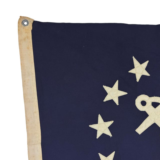 This modified vintage flag is made from a thin cotton cloth and newly embellished with an American yacht ensign emblem....