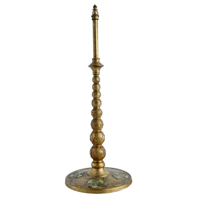 DETAILS This antique Tiffany Furnaces table lamp is a gilt bronze inverted torch candlestick. The shaft is arranged in a...
