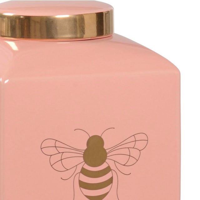 A modern version of a traditional ceramic ginger jar by Wildwood Home. Coral pink color, featuring a royal bee in metallic...