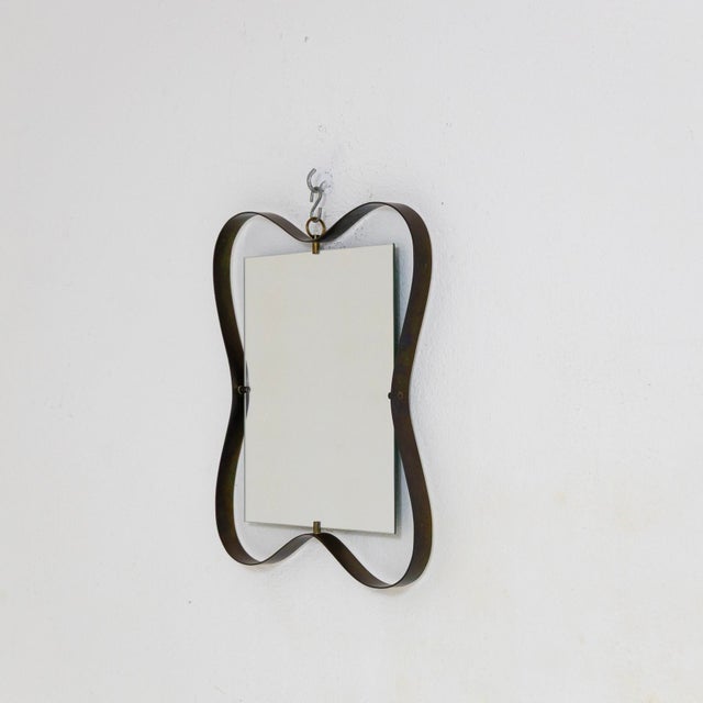 Mirror with brass frame, a variation of Fontana Arte's 1316 model. The mirror has been replaced. I have official proof of...