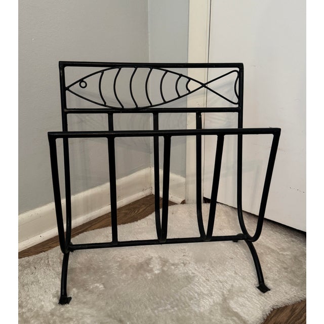 Whimsical mid-century French Modern magazine rack crafted from solid wrought iron, or fer forgé, with a sculptural fish...