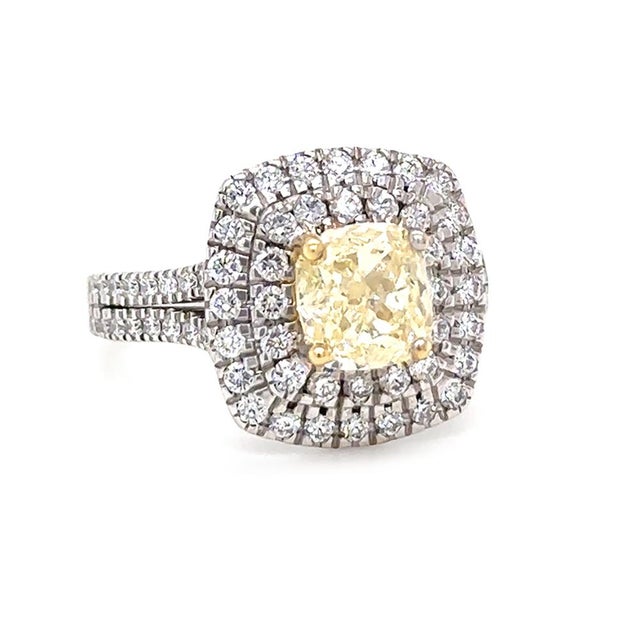 An elegant 18ct white gold diamond dress ring featuring a cushion cut natural diamond as the centrepiece, set within a...