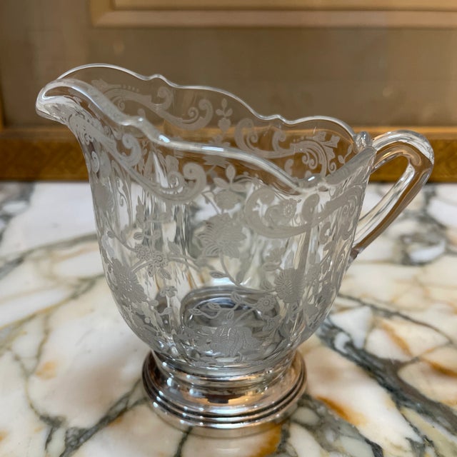 A beautiful set of etched glass sugar and creamer set with sterling silver bottoms. Great condition, no dents or cracks