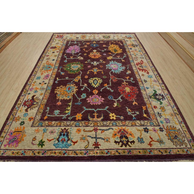A modern traditional Anatolia rug hand-knotted with an all-wool pile on a cotton foundation. This oriental rug features an...