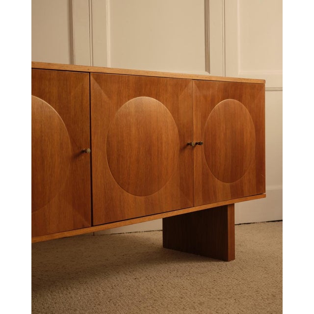 Geometric-style sideboard featuring three raised circular motifs on the doors. A fine example of cabinetmaking craftsmanship.