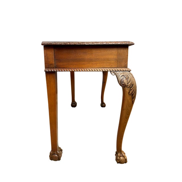 Chippendale Revival mahogany three-drawer console table, English, circa 1880, of bowed-front form, the top with stylized...