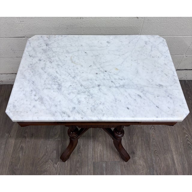 This is a gorgeous late 19th-century Victorian Eastlake / Renaissance Revival center or parlor table crafted in walnut...