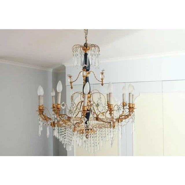 A 19th century neoclassical style crystal and gilt bronze, twelve-light chandelier centered with opal blue glass. Up to...