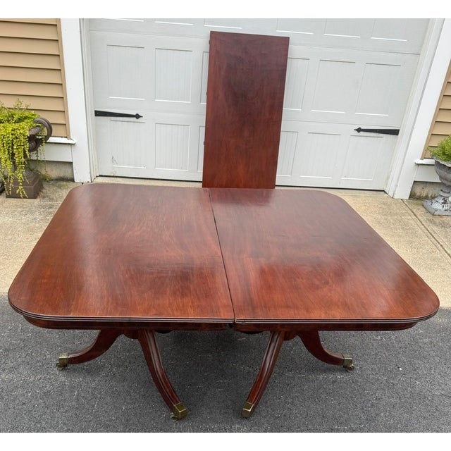 Hard to find antique American 2 pedestal mahogany dining table with 1 leaf. Table was made in the Northeast about 1825....