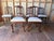 Antique French provincial style Carved Oak Dining Chairs Each features an openwork back with pierced scroll motifs and...