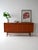 Vintage 1950s/60s sideboard in teak with three lockable doors and three small drawers. The sideboard is divided into three...