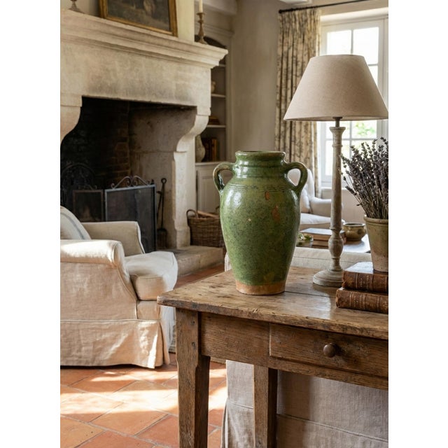 A superb 19th century French Provençal green glazed terracotta olive jar or urn. These jars were used for storing and...