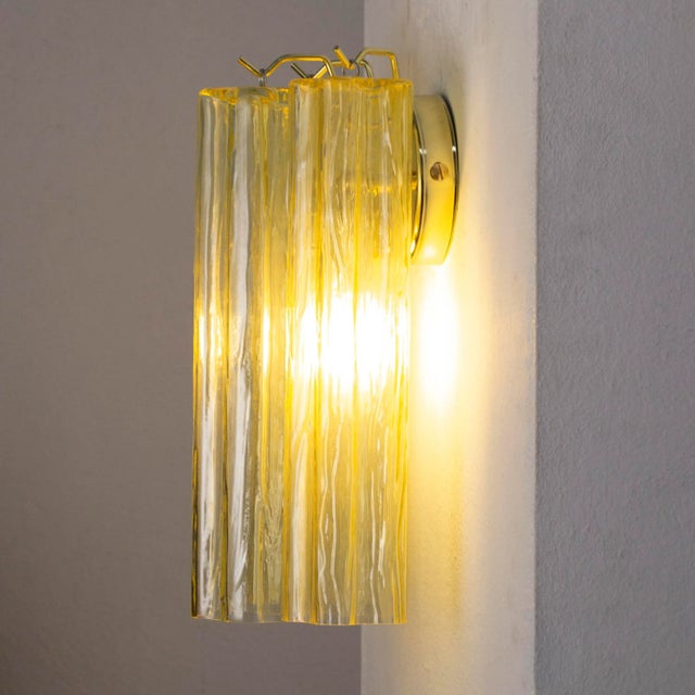 "tronchi" wall applique is made up of elements in blown glass tubes called "trunks" because of the shape reminiscent of a...