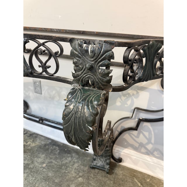 Early 20th century Art Deco ornate wrought iron console table featuring decorative ironwork. Mounted against a wall, the...