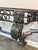 Early 20th century Art Deco ornate wrought iron console table featuring decorative ironwork. Mounted against a wall, the...