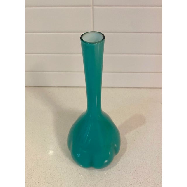 Cute sea-foam green molded cased glass vase. The long neck is offset by the plump base that is quartered with indents like...