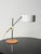 Adjustable "Olympia" table lamp in white lacquered metal and chromed steel, leather-covered base. Designed by Anders...