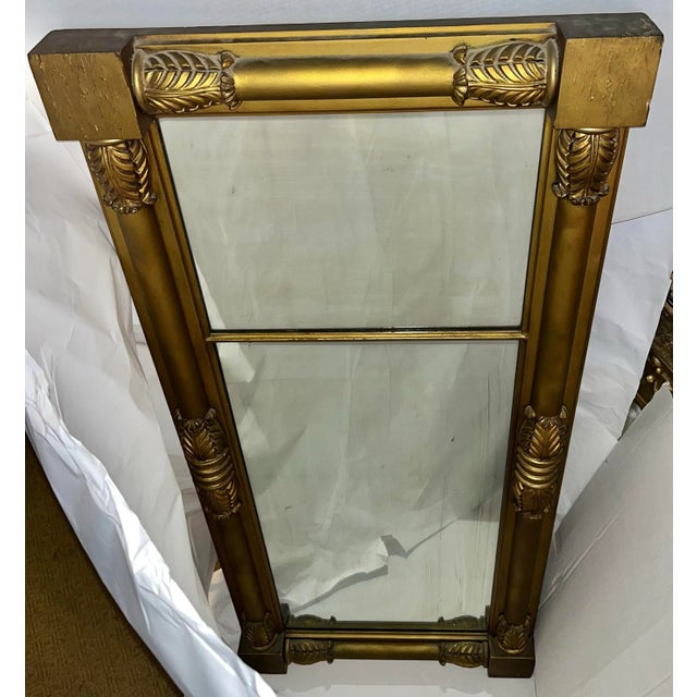 A nice vintage large verticals gold gilt mirror from Upstate New York. Classical acanthus leaves decorations. A very...
