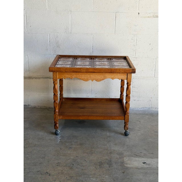 This versatile rolling service table exhibits a strong combination of traditional country craft and mid-century utility....