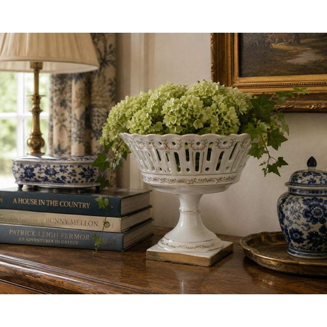 A refined reticulated porcelain basket, executed in a neoclassical idiom with delicate openwork and restrained gilt...
