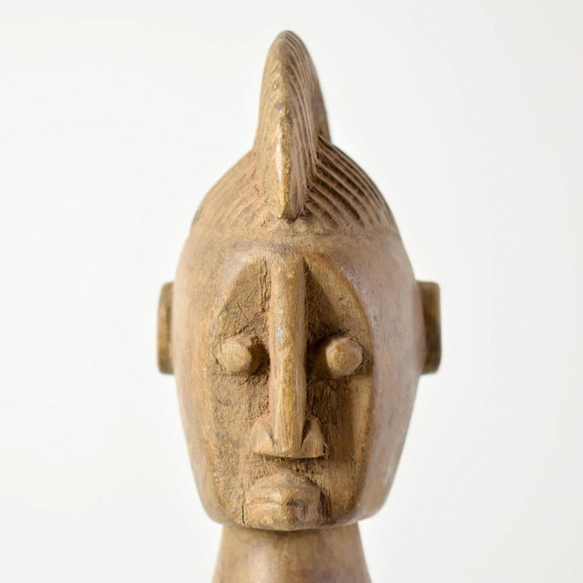 The Bozo Female Maternity Figure from Mali is a beautifully carved wooden sculpture that stands out for its angular...