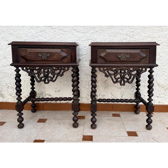 Elegant pair of Portuguese bedside tables dating from the 1940s, featuring a practical drawer with its original decorative...