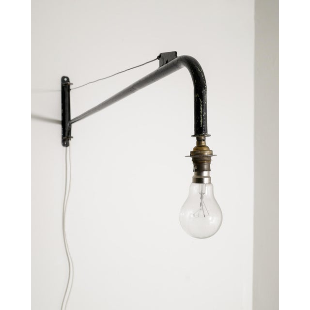 A rare and iconic french mid century wall / swing "potence" jib wall lamp in black lacquered metal attributed to jean...