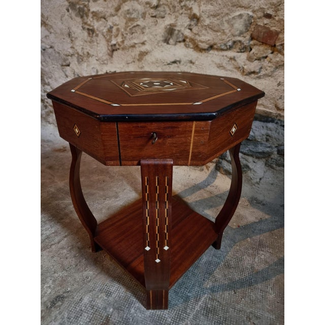 French inlaid side table or sewing table dating from approximately 1930–1950. Crafted from mahogany and contrasting...