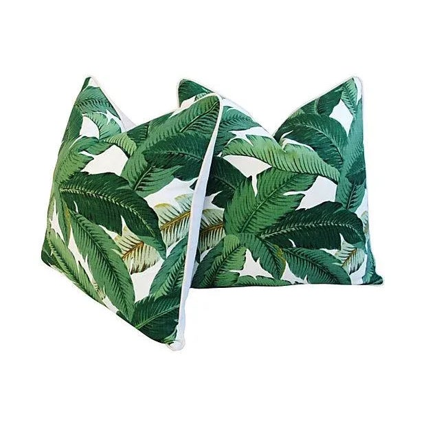 Pair of custom-tailored pillows in an iconic tropical banana leaf print fabric. Pillow's backs are complementary off-white...