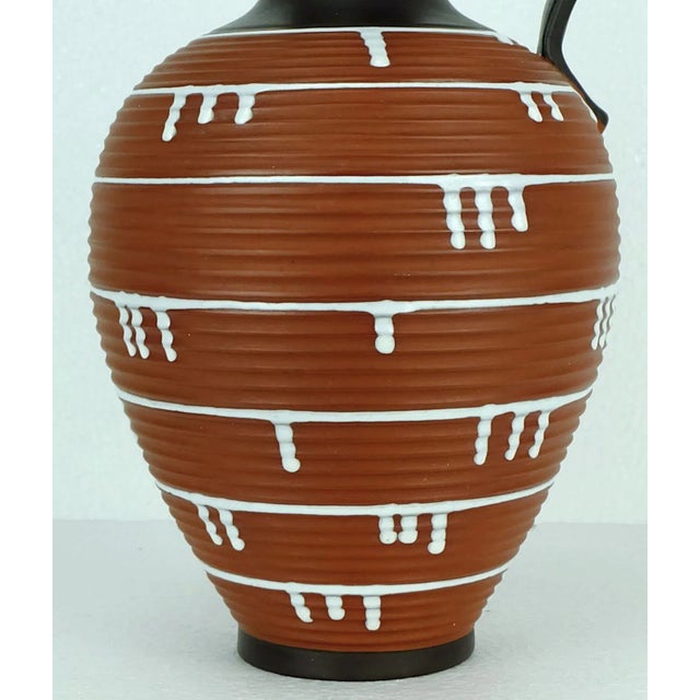 - Large jug vase by Ilkra from 1959 - "Palermo" decor - Model no. 52/35 - Brown glaze - Non glazed surfaces with a grooved...
