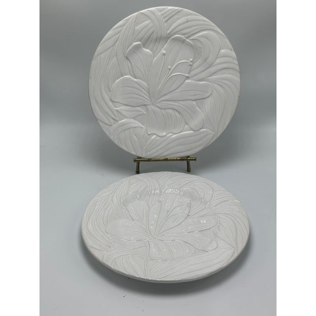 Elegant pair of vintage Bordallo Pinheiro Portuguese majolica plates, each decorated with a large raised tropical flower...