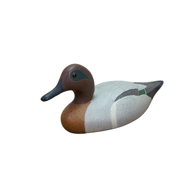 Exceptional folk art Green-Winged Teal drake decoy was handcrafted in 1977 by The Decoy Shop. Carved from solid white...
