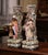 A richly modeled pair of antique French barbotine vases, each conceived as a picturesque architectural scene with a finely...