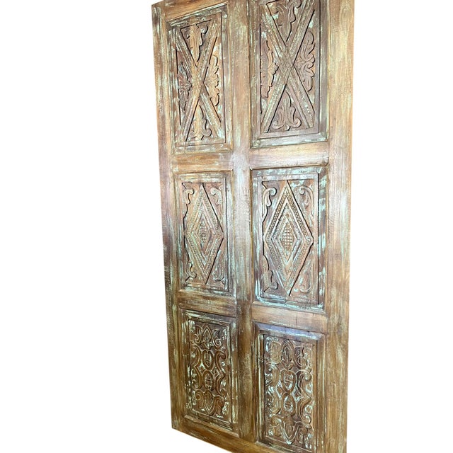 A striking piece of architectural history, this hand-carved wooden door was reclaimed from a rustic farmhouse and...