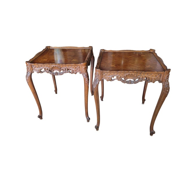 This pair of Louis XV Revival side tables embodies French elegance, with gracefully curved cabriole legs, richly carved...