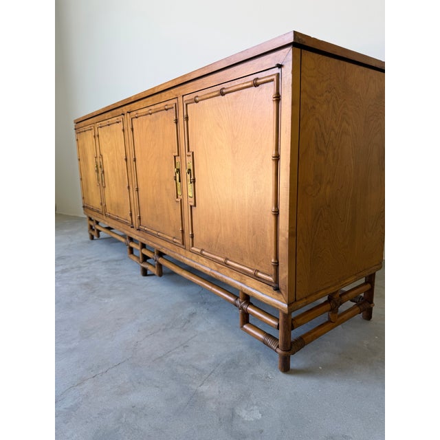Elegant vintage sideboard by Ficks Reed featuring a classic Palm Beach aesthetic with beautifully crafted faux bamboo...