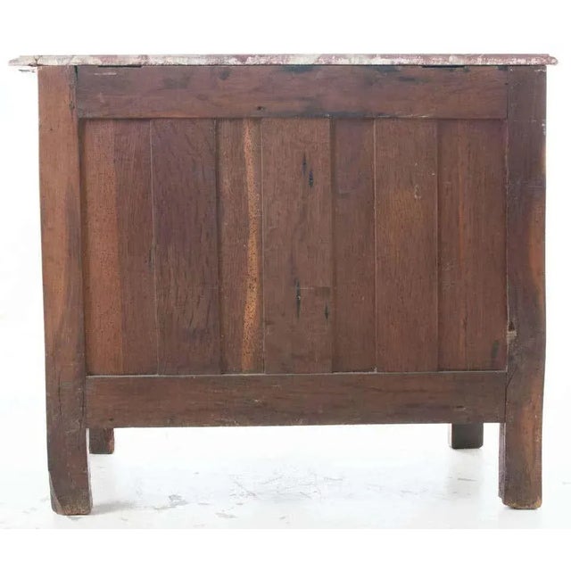 French fruitwood Parisian Regence marble-top commode, circa early 1700s. An exquisite red marble surface with slight bow...