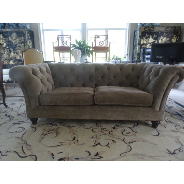 This made to order sofa is called the aspen sofa with button tufting with custom wood turned legs. In a brown Denim like...