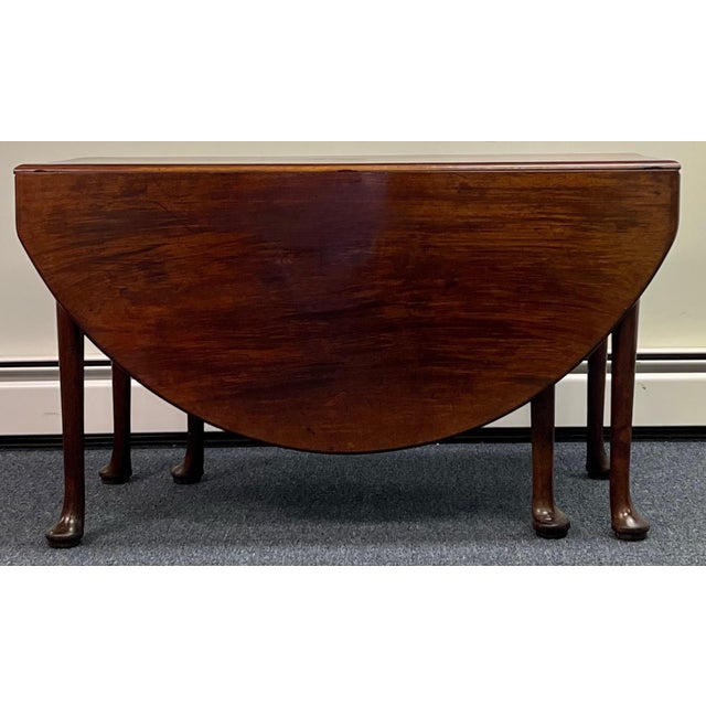 18th century Queen Anne mahogany drop leaf dining table. Deep 20” semi circular leaves form a 61” X 49” oval dining table...