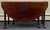18th century Queen Anne mahogany drop leaf dining table. Deep 20” semi circular leaves form a 61” X 49” oval dining table...